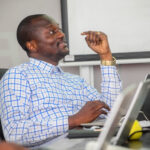 Gaël Mulangu attending the meeting at Baobab RDC being conducted by David Muanda, CEO at Friendina College
